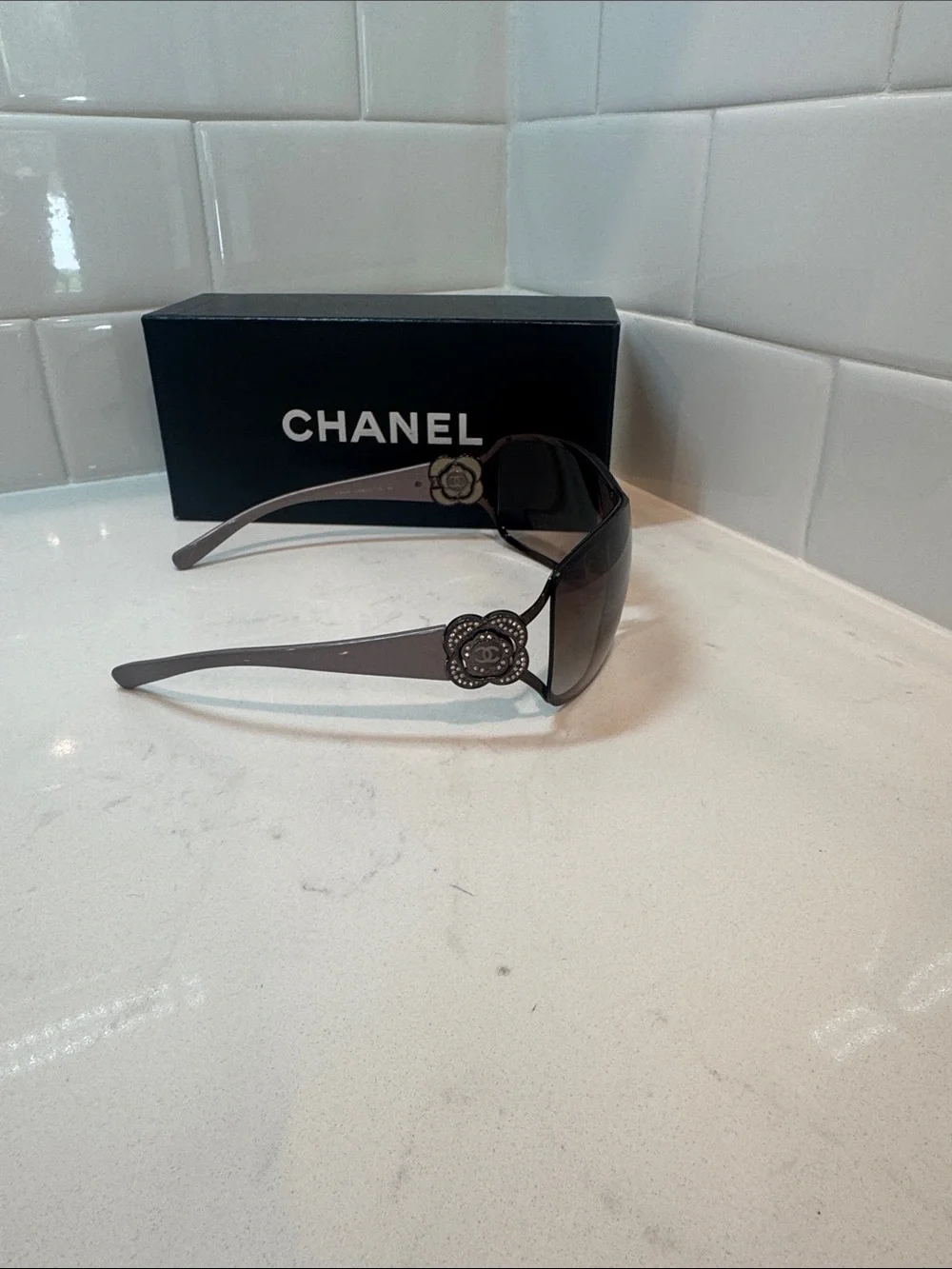 Chanel  Camellia flower with crystal-embellished interlocking CC logo